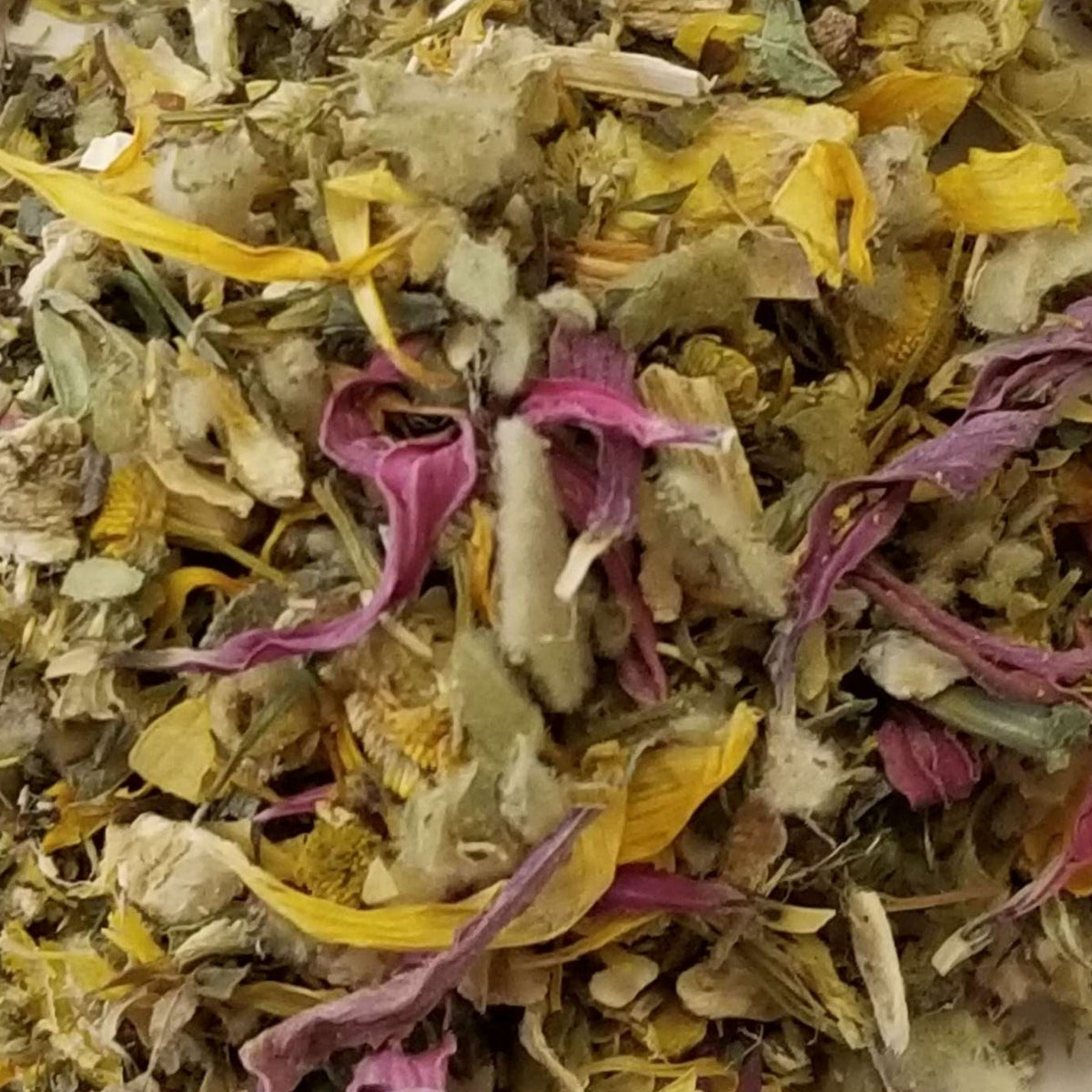 A mixture of dried herbs and flowers, likely ingredients for a cough soothing tea blend.
